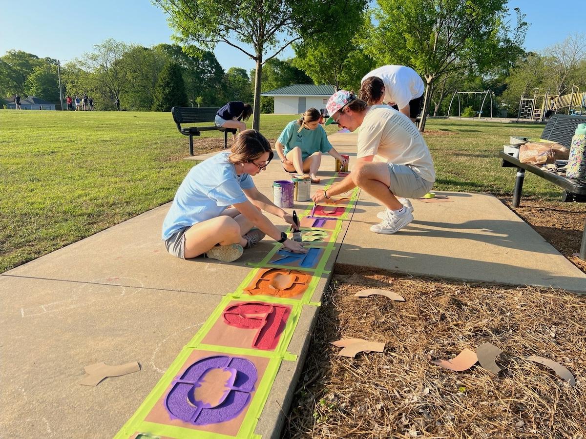 Students painting local playground